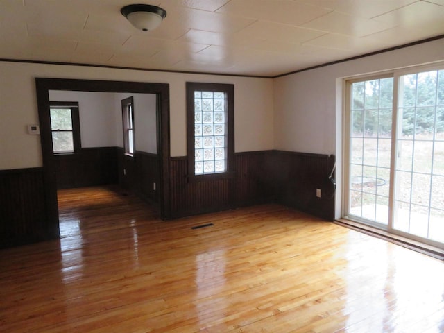 unfurnished room with hardwood / wood-style flooring and a wealth of natural light