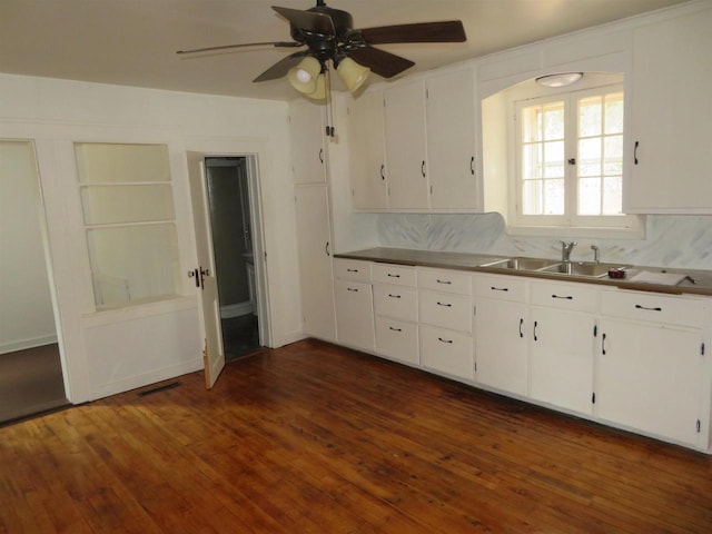 kitchen with sink, dark hardwood / wood-style floors, ceiling fan, tasteful backsplash, and white cabinetry