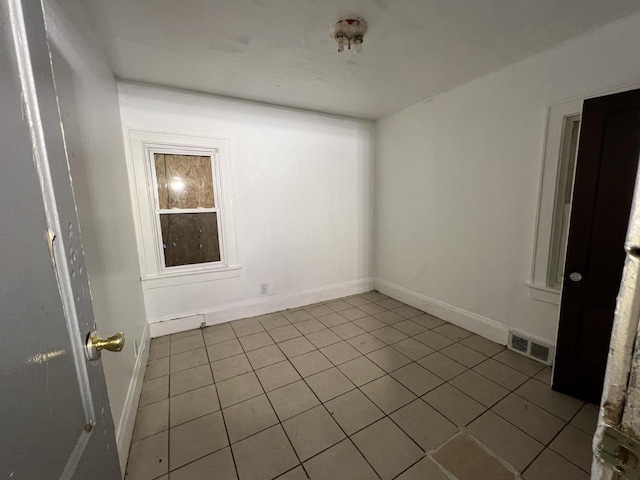 unfurnished room featuring tile patterned flooring