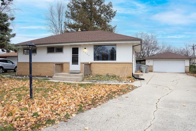 single story home featuring an outbuilding and a garage