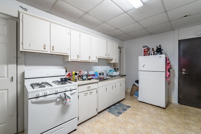 kitchen featuring white cabinets, a paneled ceiling, and white appliances