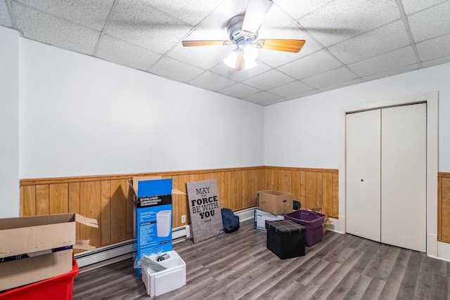 miscellaneous room featuring a paneled ceiling, hardwood / wood-style floors, and a baseboard radiator