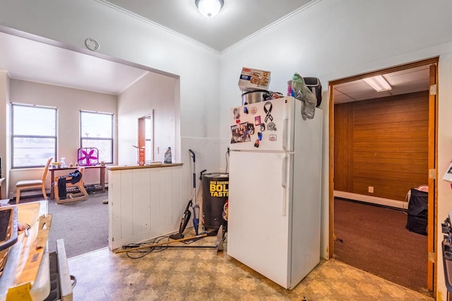 kitchen with white fridge, ornamental molding, and light carpet