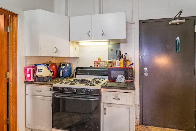 kitchen with white cabinetry and gas range gas stove