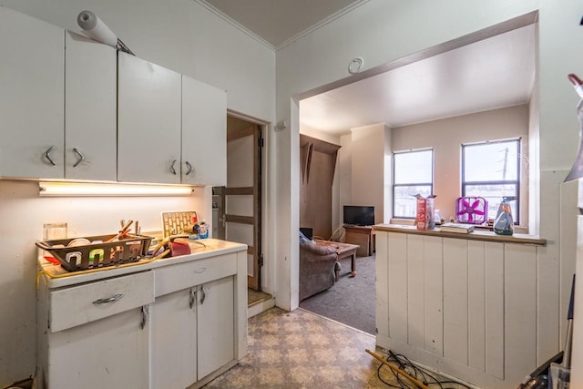 kitchen featuring white cabinets and ornamental molding