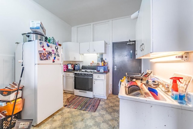 kitchen featuring crown molding, white cabinets, and white appliances