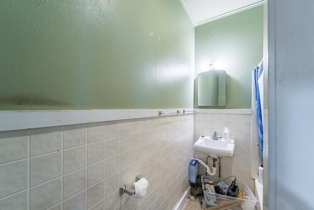 bathroom with tile walls and ornamental molding