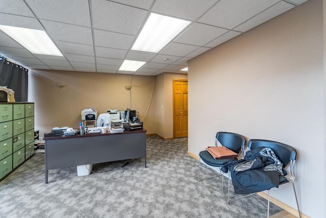 carpeted home office with a drop ceiling