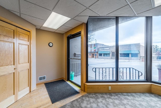 entryway featuring a paneled ceiling and hardwood / wood-style flooring