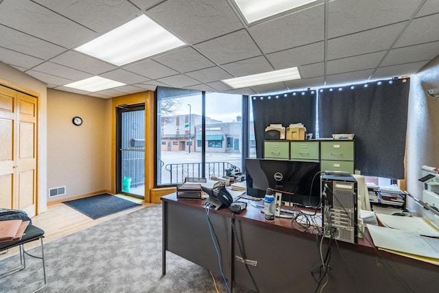 office featuring a drop ceiling and wood-type flooring