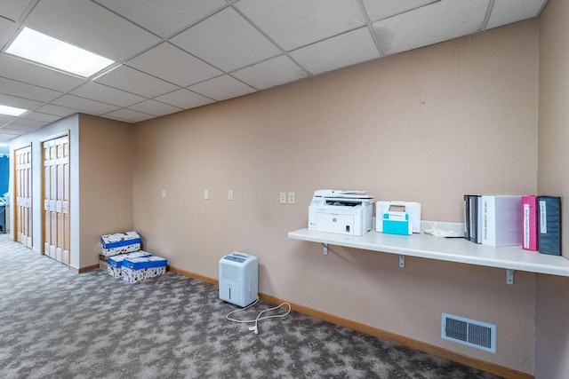 interior space featuring a drop ceiling and carpet