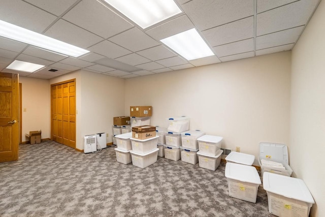 interior space featuring a drop ceiling and carpet floors