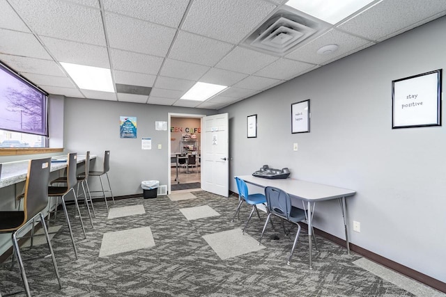 carpeted office space featuring a drop ceiling