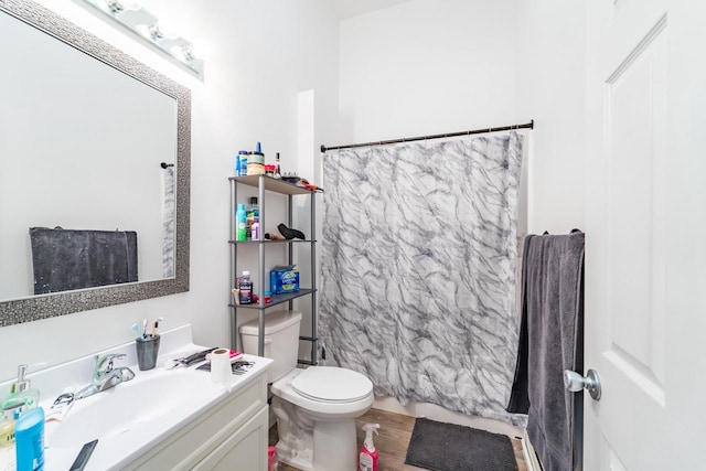 bathroom featuring a shower with shower curtain, vanity, toilet, and hardwood / wood-style floors