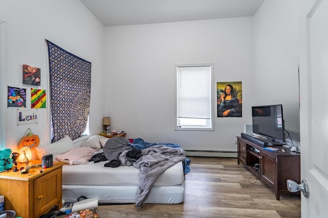 bedroom featuring light hardwood / wood-style floors and baseboard heating