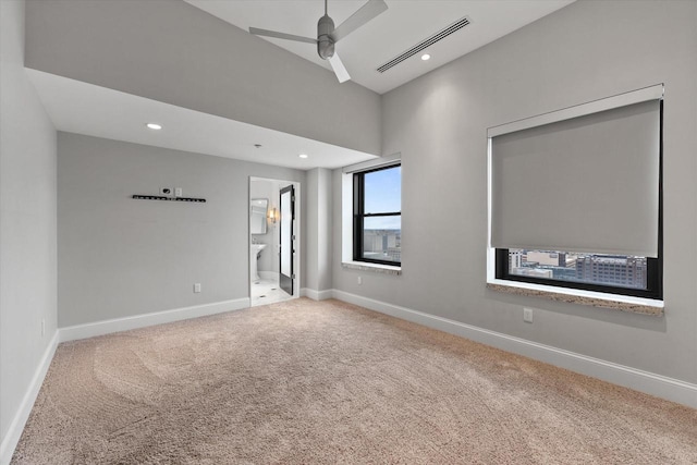 carpeted spare room with ceiling fan
