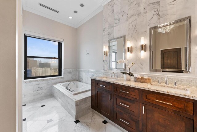 bathroom featuring vanity, tile walls, crown molding, and tiled tub
