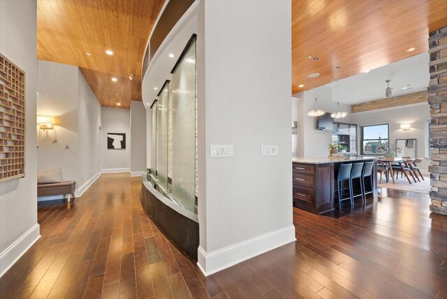 corridor featuring wooden ceiling and dark wood-type flooring