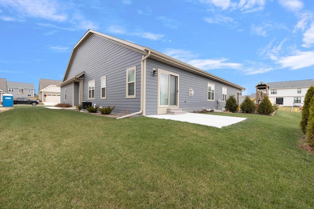 back of house featuring a lawn, central air condition unit, and a garage