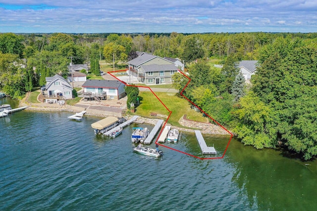 7134 N Tichigan Rd, Waterford, WI 53185 - aerial view of property's location featuring a heavily wooded area, a nearby body of water, and property boundaries highlighted