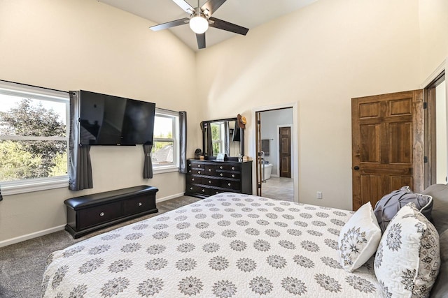 7134 N Tichigan Rd, Waterford, WI 53185 - carpeted bedroom with baseboards, a towering ceiling, ensuite bath, and a ceiling fan