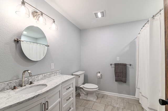 7134 N Tichigan Rd, Waterford, WI 53185 - bathroom with vanity, toilet, and baseboards