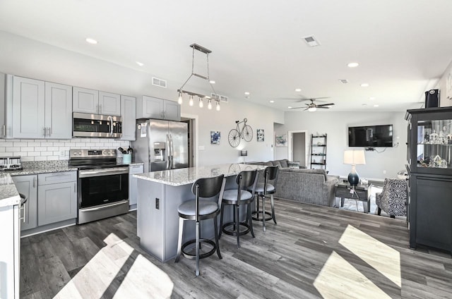 7134 N Tichigan Rd, Waterford, WI 53185 - kitchen featuring stainless steel appliances, dark wood finished floors, recessed lighting, a ceiling fan, and tasteful backsplash