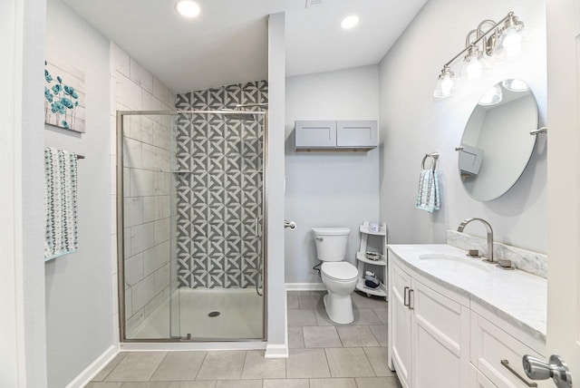 7134 N Tichigan Rd, Waterford, WI 53185 - full bath featuring vanity, toilet, a shower stall, tile patterned flooring, and recessed lighting