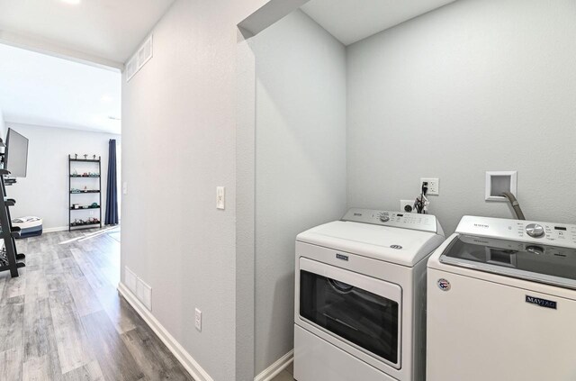 7134 N Tichigan Rd, Waterford, WI 53185 - laundry room with independent washer and dryer, light wood finished floors, and baseboards