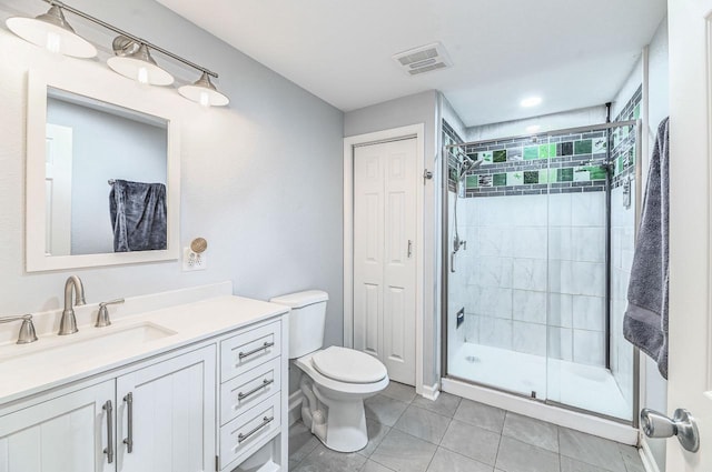 7134 N Tichigan Rd, Waterford, WI 53185 - full bathroom featuring vanity, toilet, tile patterned floors, and a shower stall