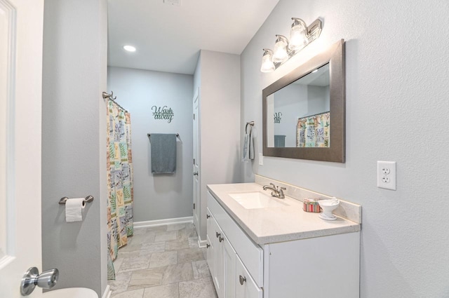 7134 N Tichigan Rd, Waterford, WI 53185 - full bath with vanity, baseboards, and a shower with shower curtain