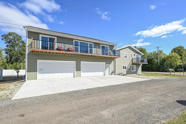 7134 N Tichigan Rd, Waterford, WI 53185 - view of front of house featuring an attached garage, driveway, and a balcony