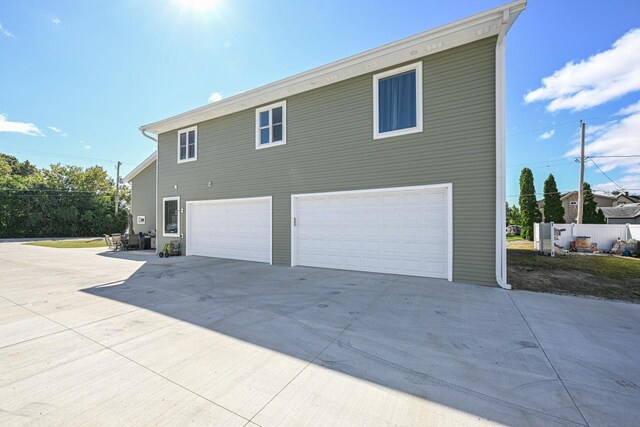 7134 N Tichigan Rd, Waterford, WI 53185 - view of property exterior featuring an attached garage and driveway