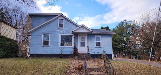 bungalow-style home with a front lawn