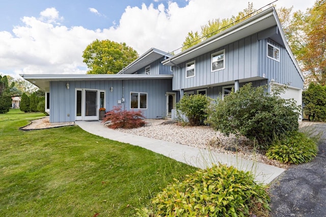 rear view of property with a yard