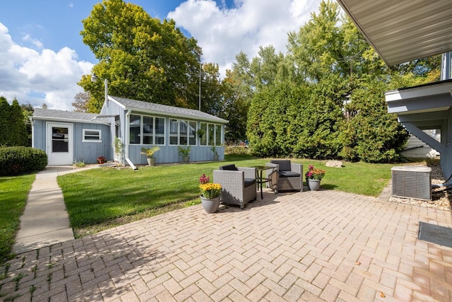 view of patio / terrace with cooling unit and a sunroom