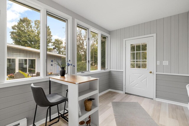 4705 Highland Park Dr, Slinger, WI 53086 - sunroom / solarium featuring wood walls, wood finished floors, baseboard heating, baseboards, and french doors