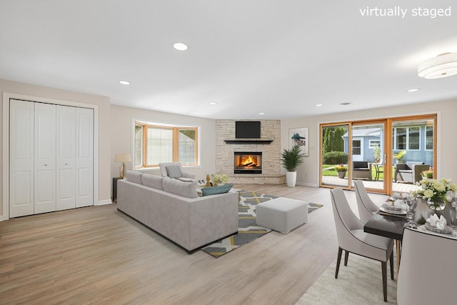 4705 Highland Park Dr, Slinger, WI 53086 - living room with light wood finished floors, healthy amount of natural light, a stone fireplace, and recessed lighting