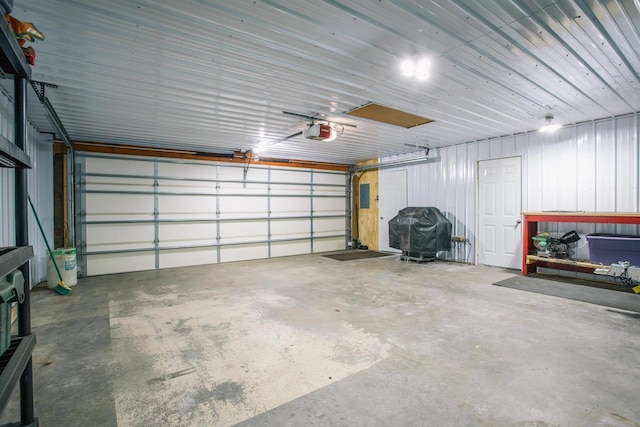 garage with electric panel and a garage door opener