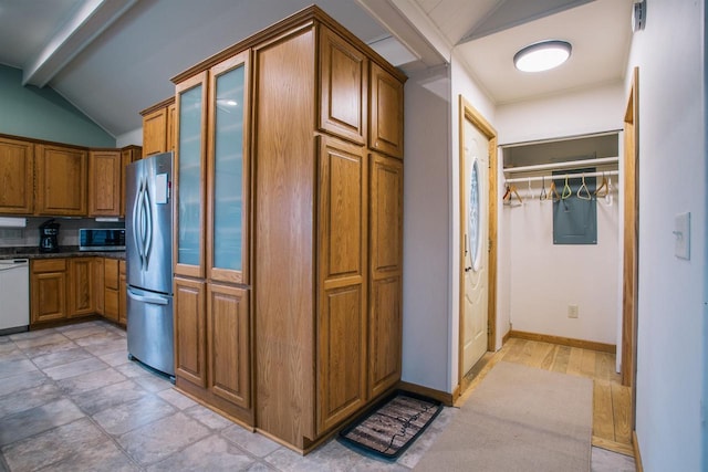 kitchen with vaulted ceiling with beams and stainless steel appliances