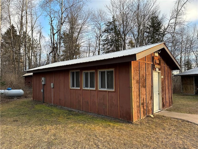 view of outbuilding featuring a lawn