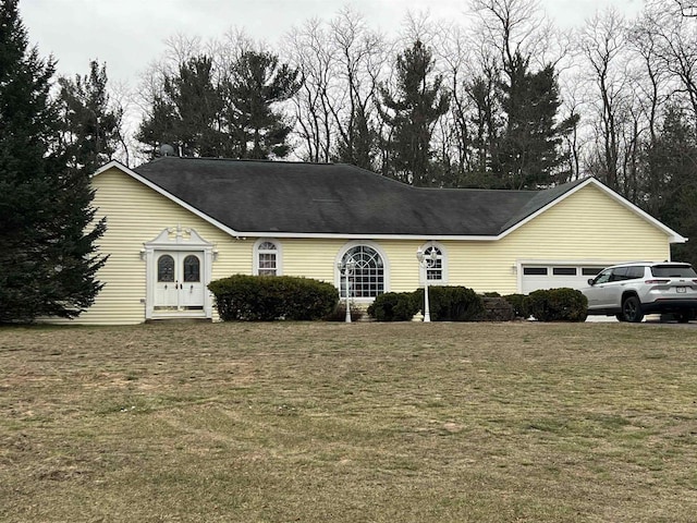 single story home with a garage and a front yard