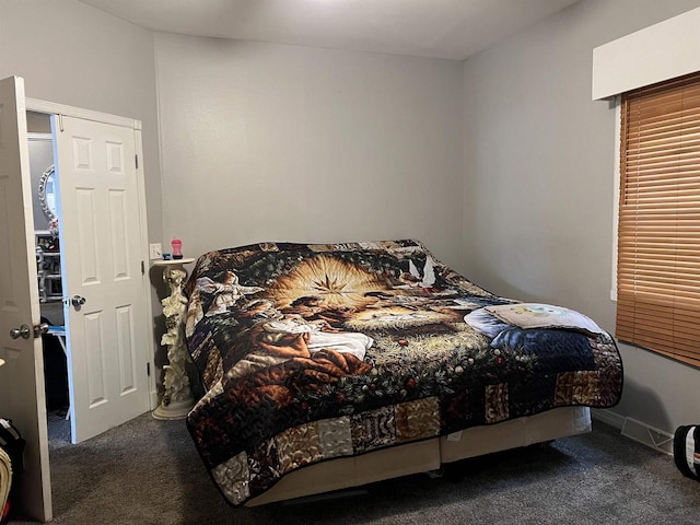 bedroom featuring dark carpet