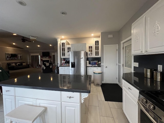 kitchen with white cabinetry, a center island, ceiling fan, and stainless steel appliances