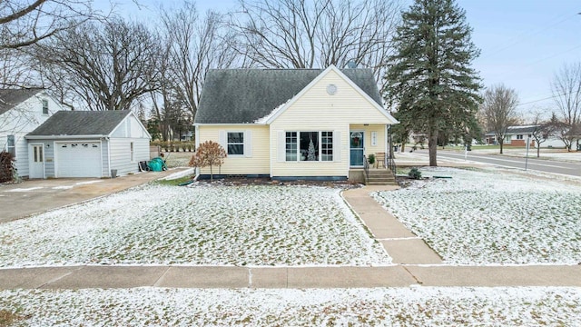 view of front facade featuring a garage and an outbuilding