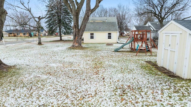 view of yard featuring a storage shed and a playground