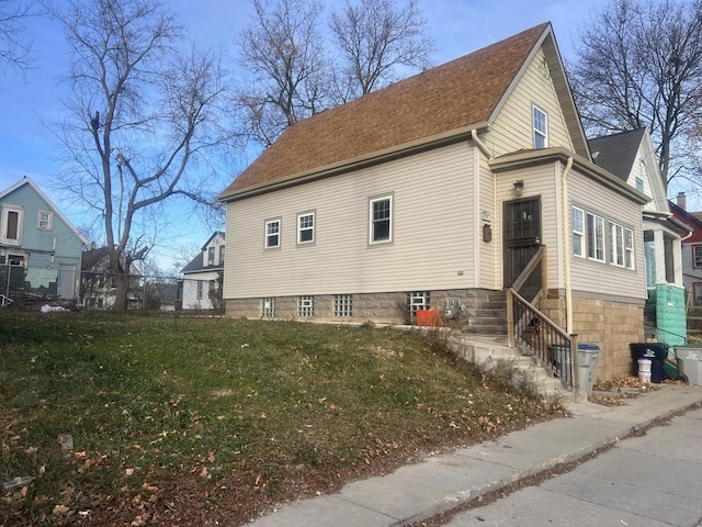 view of home's exterior with a lawn