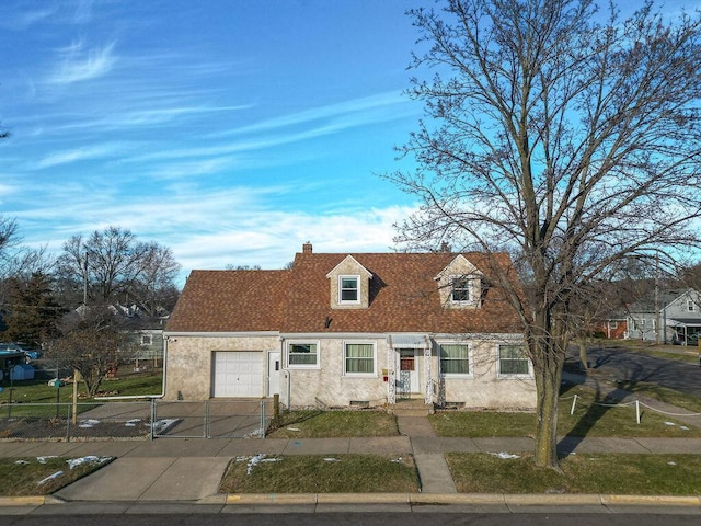 cape cod-style house with a garage