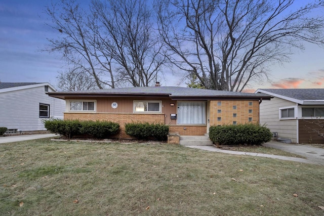 ranch-style house with a lawn