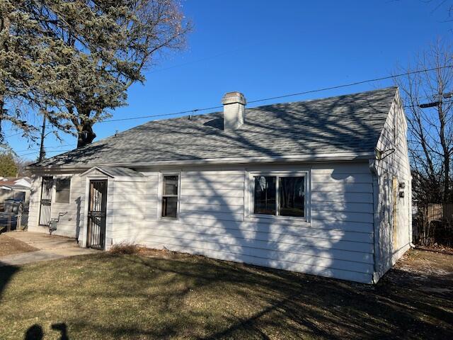 back of house with a yard